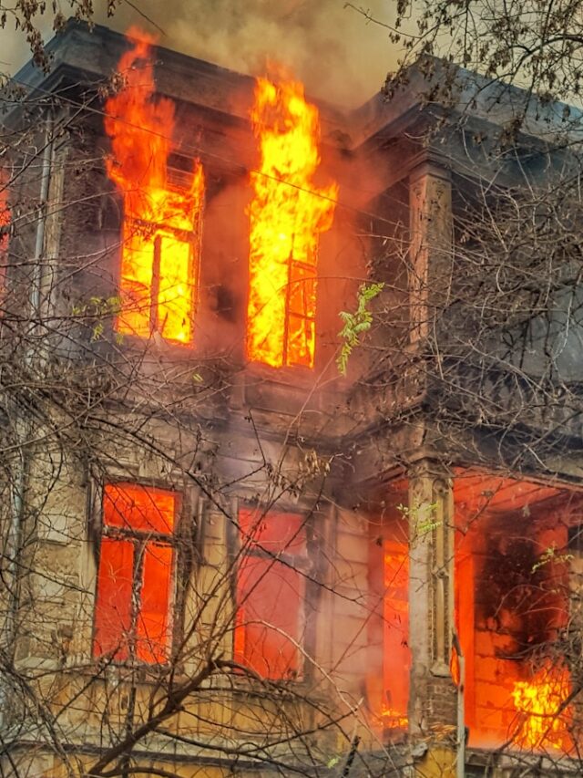 photo of burning house near trees