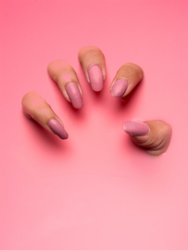 persons hand on pink surface