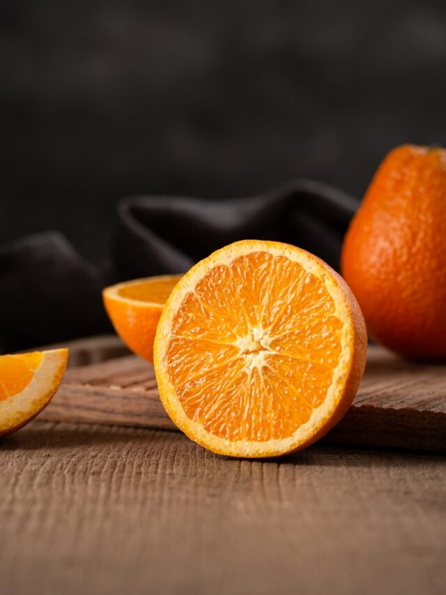 sliced orange fruit on brown wooden table