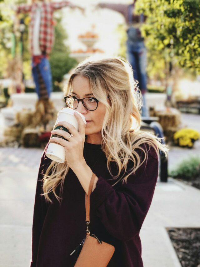 woman drinking on white cup