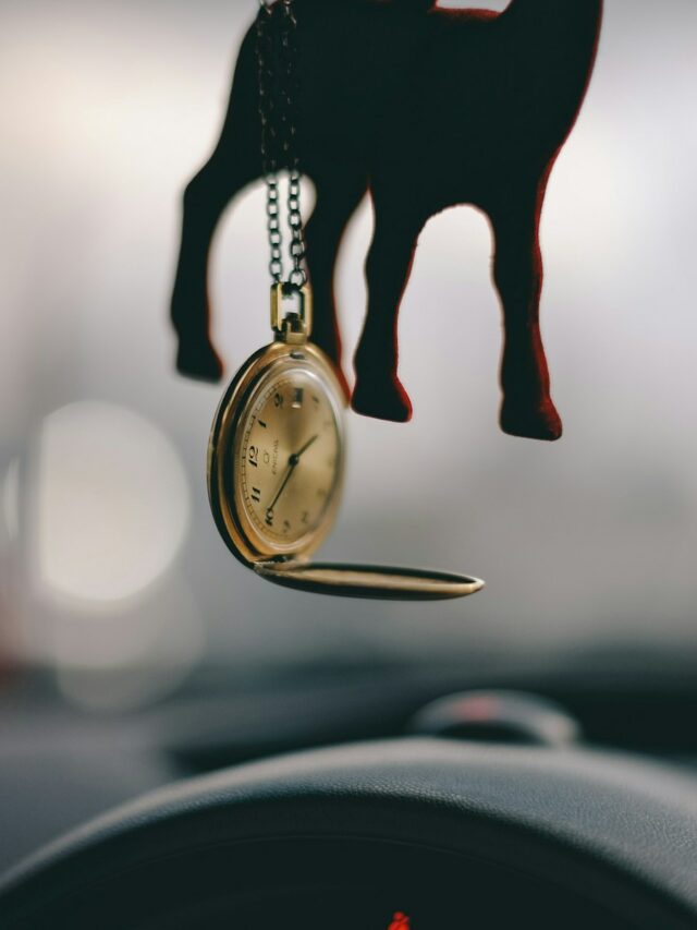 tilt shift lens photography of gold-colored pocket watch