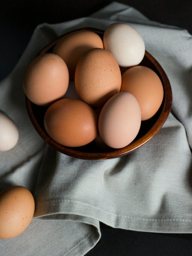 beige and white eggs on brown wooden bowl