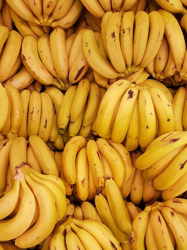 yellow banana fruit on brown wooden table