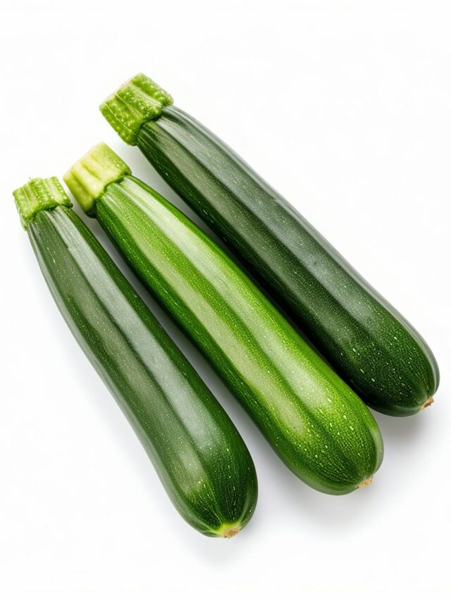 three green cucumbers on a white background