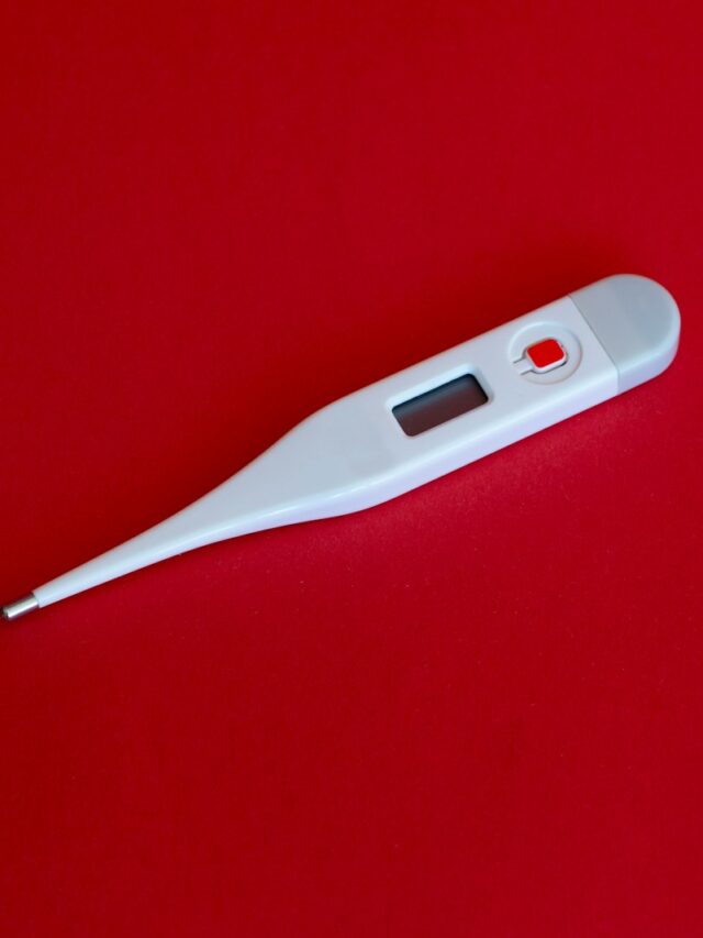 white thermometer on red surface