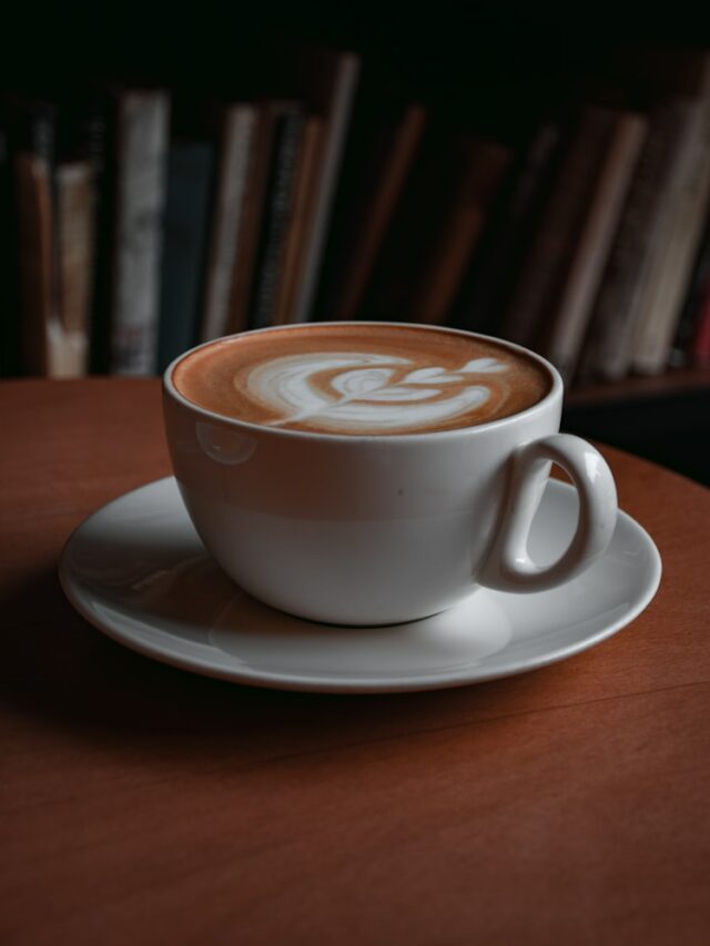 white ceramic cup with cappuccino on white ceramic saucer