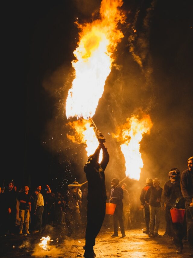 A group of people standing around a fire