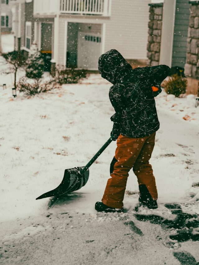 a person with a snow shovel in the snow