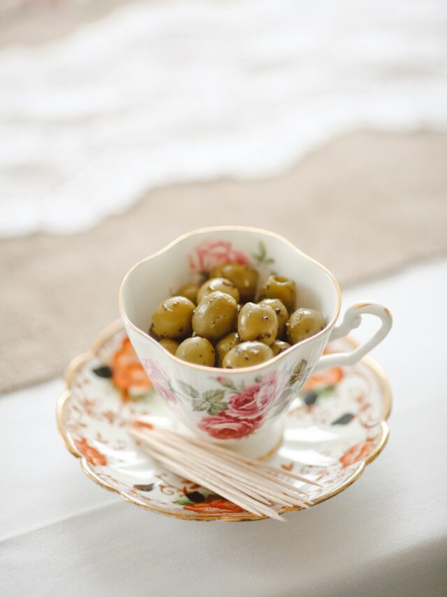 saucer plate with cup, beans and stick