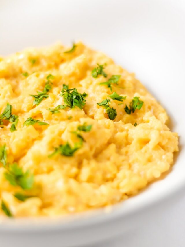 a bowl of mashed potatoes with parsley on top