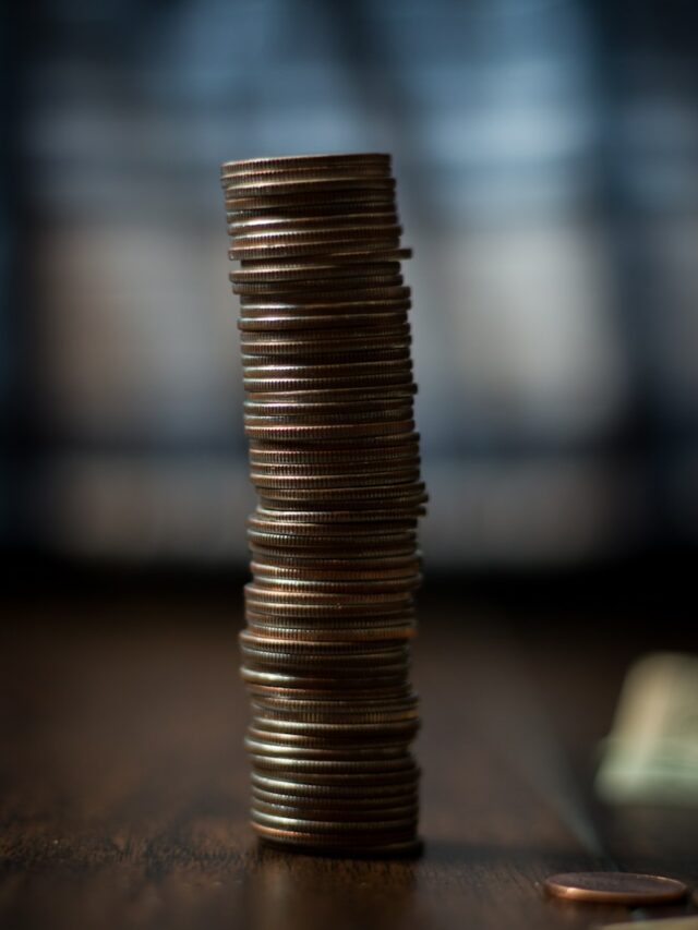 gold round coins on brown wooden table