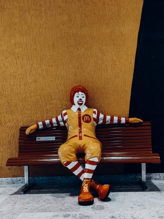 a clown sitting on a bench