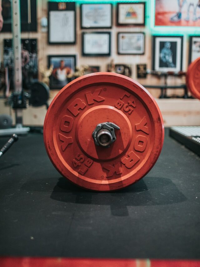 red round dumbbell on black table