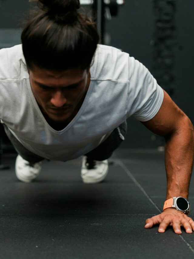 A man doing push ups in a gym