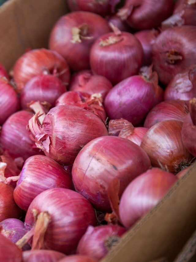 red onion on brown wooden crate