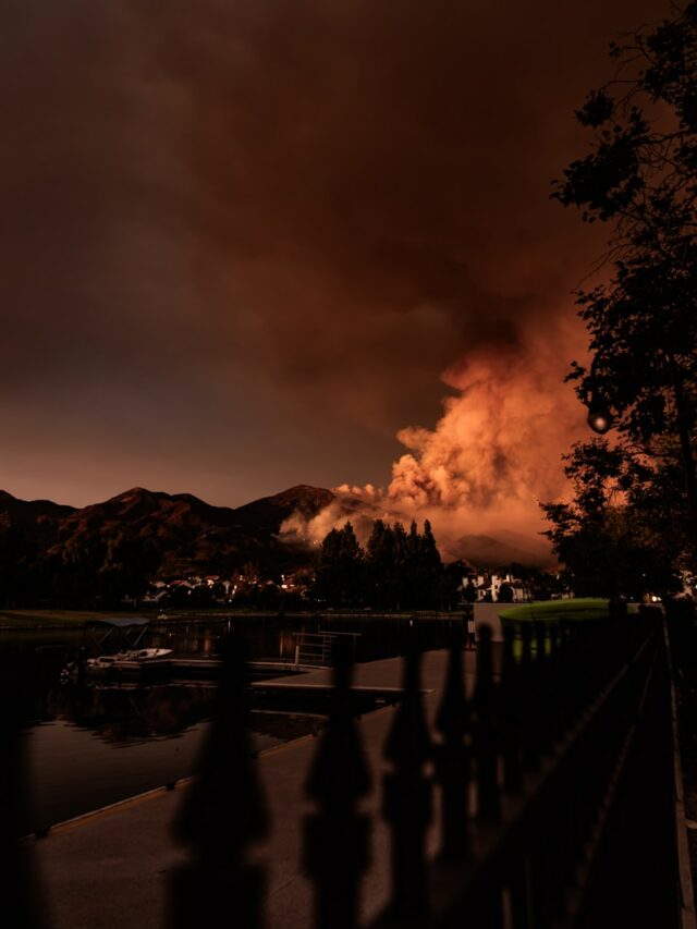 A large plume of smoke is seen in the distance