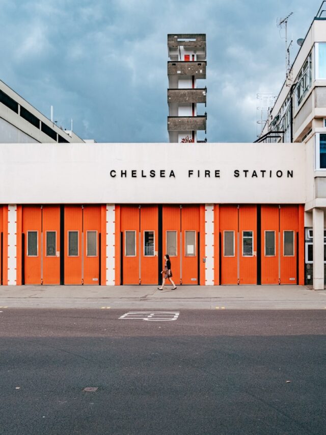 a fire station with a person walking by it