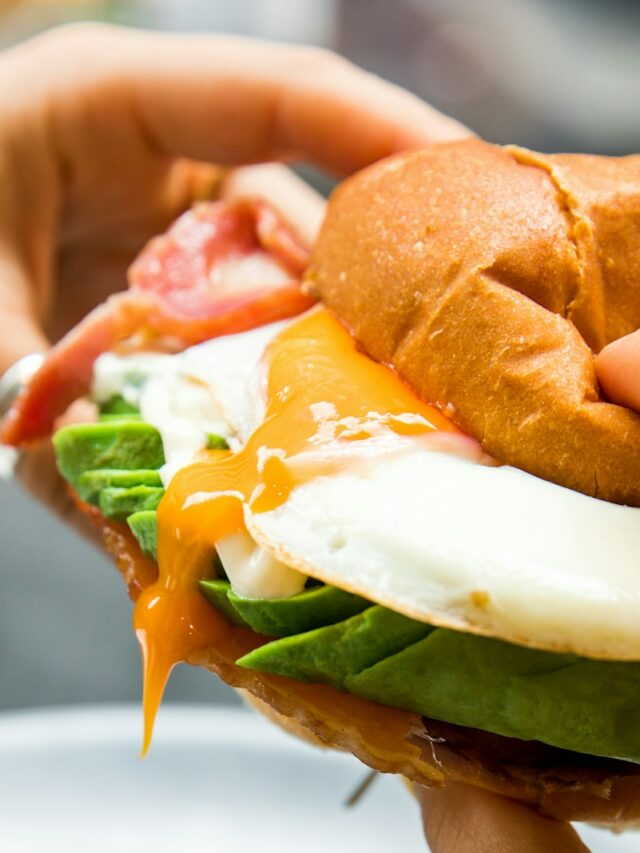 burger with lettuce and tomato on white ceramic plate