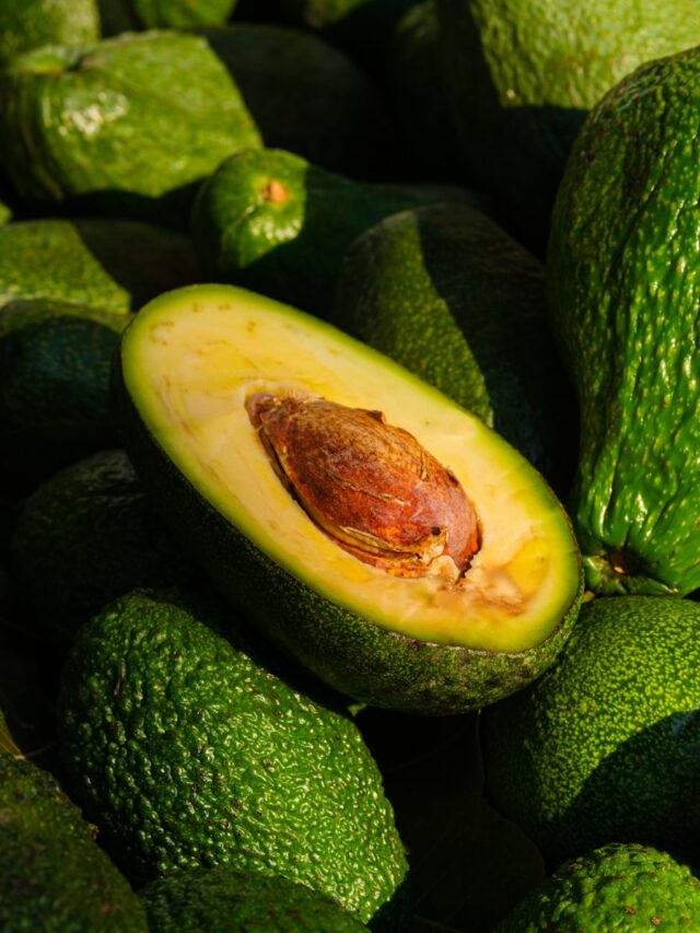 a pile of green avocados sitting on top of each other