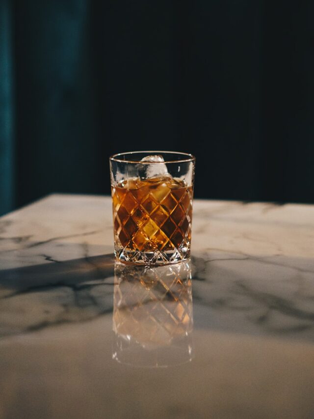 clear drinking glass with yellow liquid