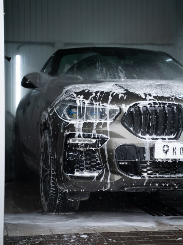 a car is covered in snow in a garage