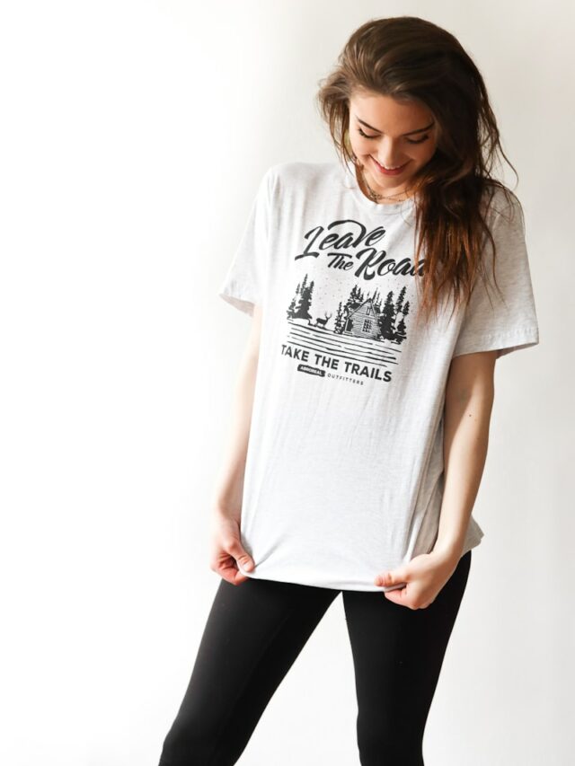 smiling woman in black and white print t-shirt