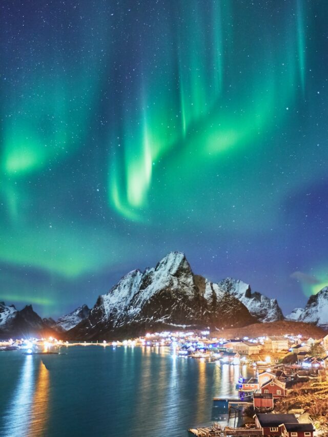 snow covered mountains near body of water during night time