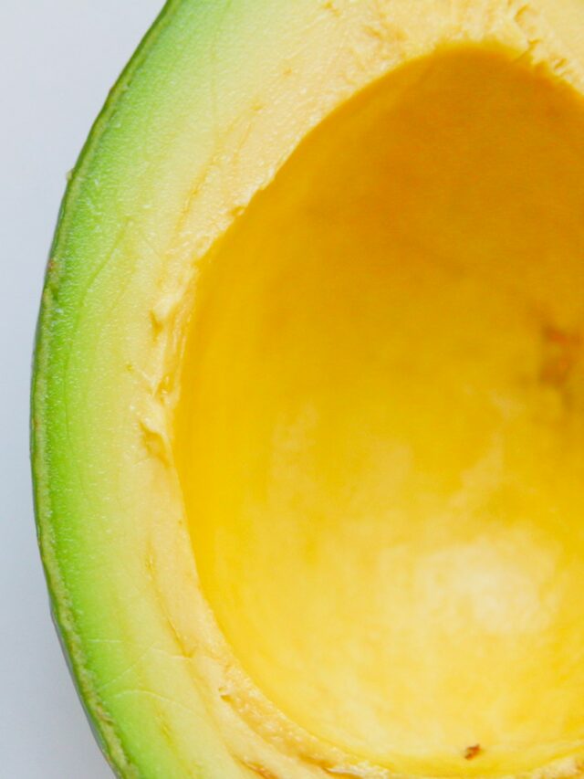 sliced avocado against white background