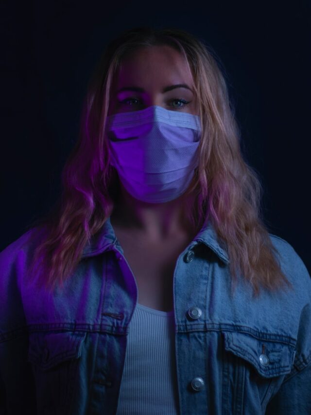 woman in purple denim jacket with white mask