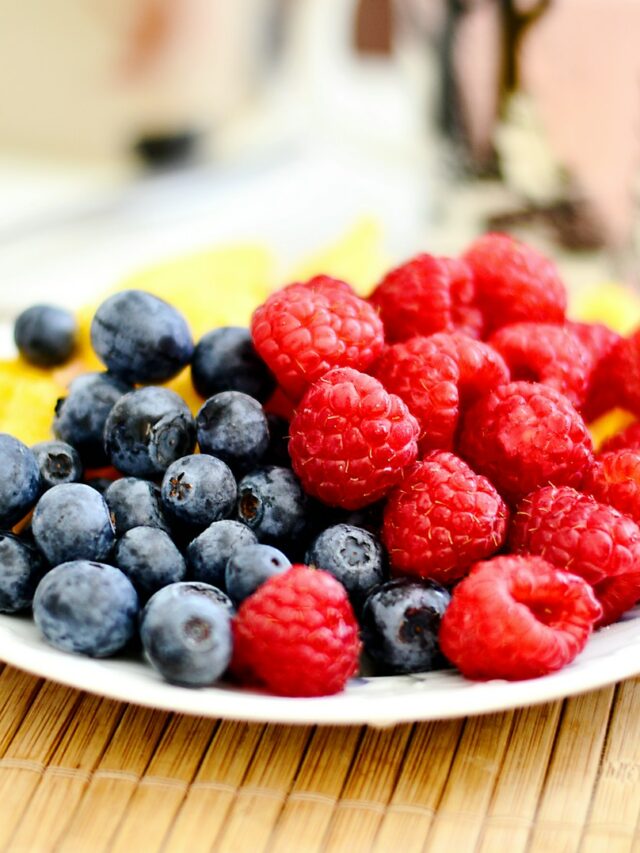 strawberries and blue berries on palte