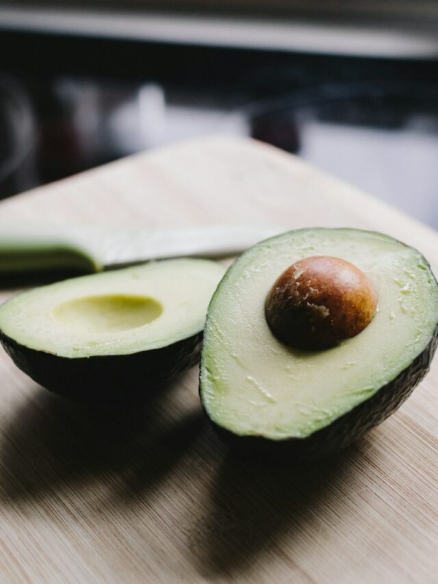 sliced avocado on brown wooden chopping board