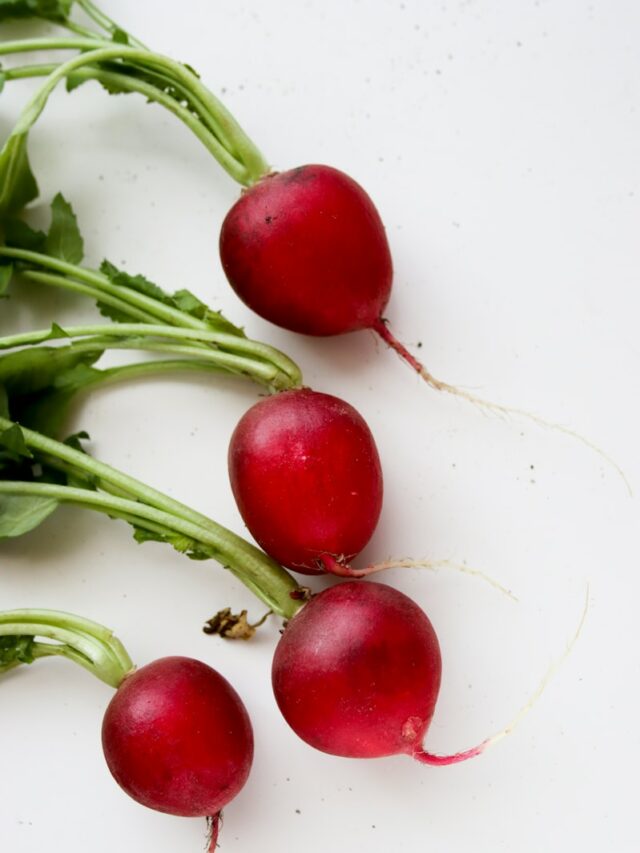 red tomato on white surface