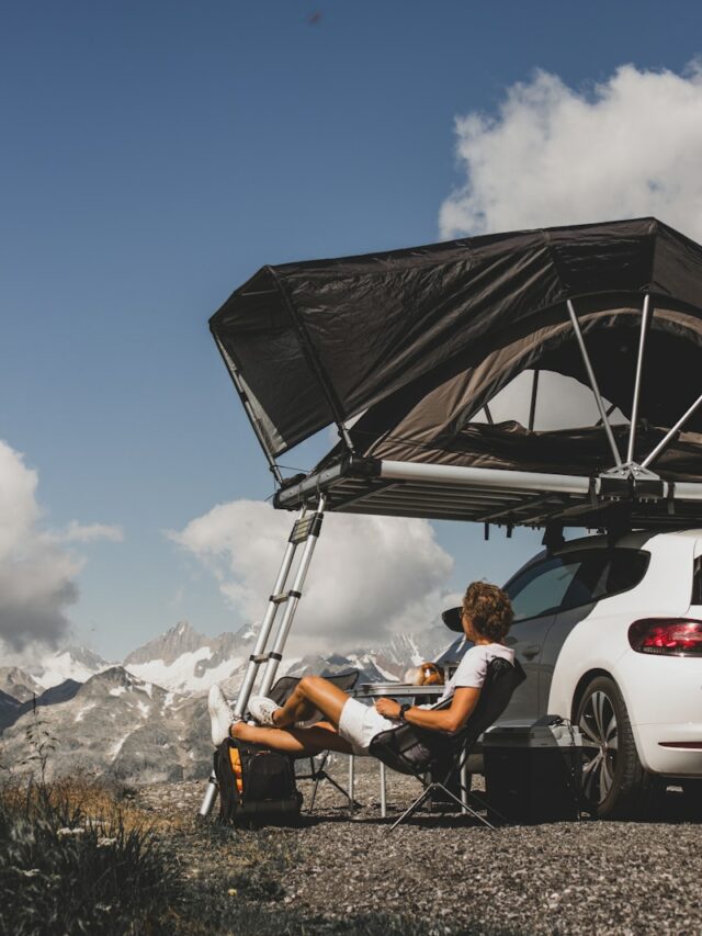 woman in white crew neck t-shirt sitting on white car during daytime