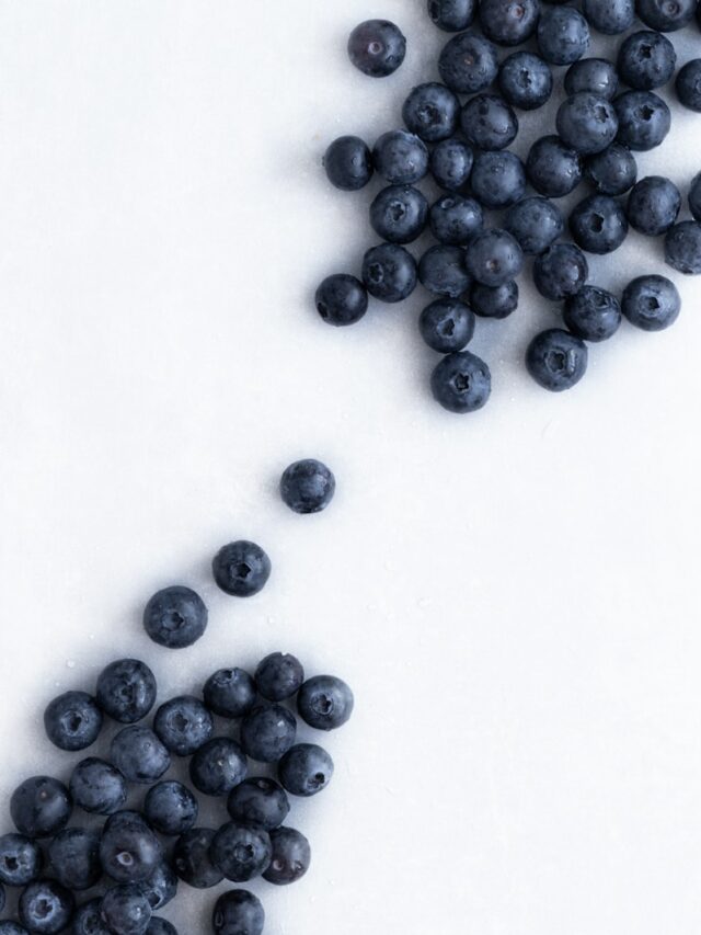 blue berries on white surface