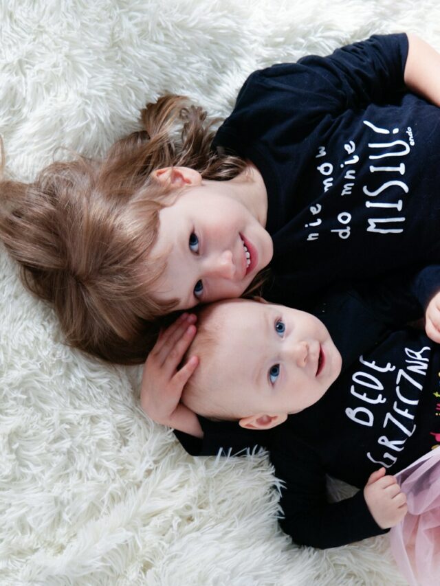 2 girls lying on white fur textile