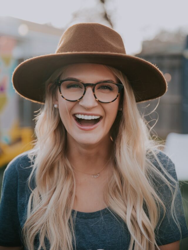 selective focus photography of smiling woman wearing brown hat